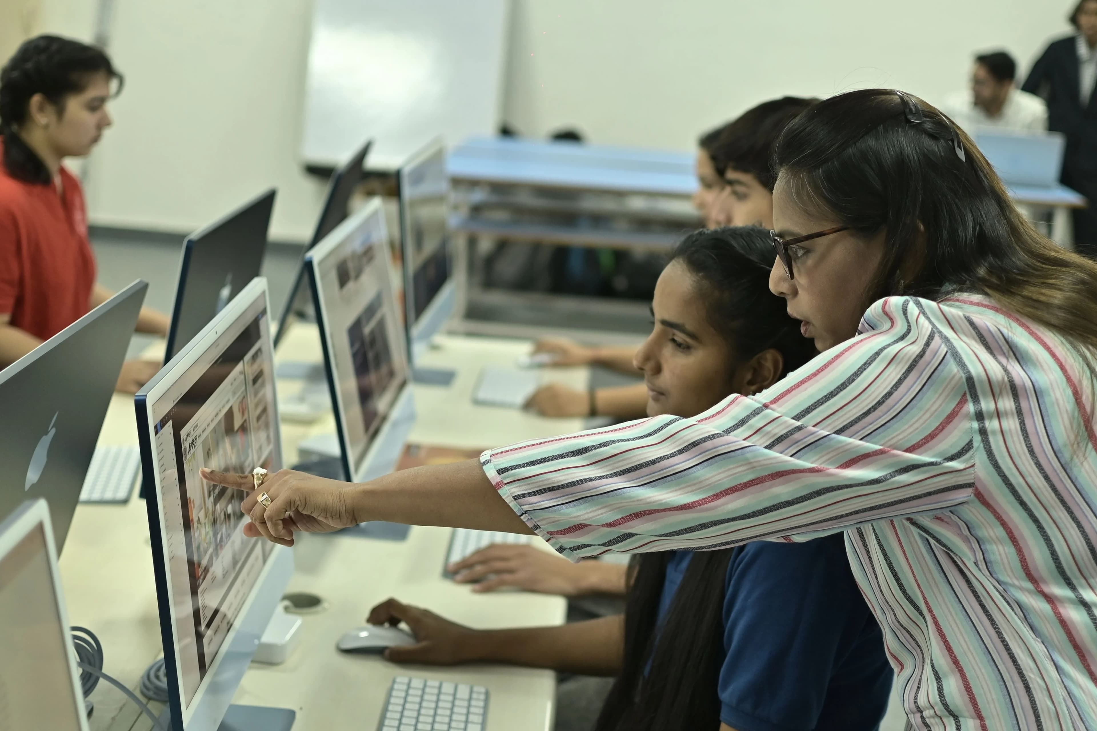 A student focused on a computer during a coding session