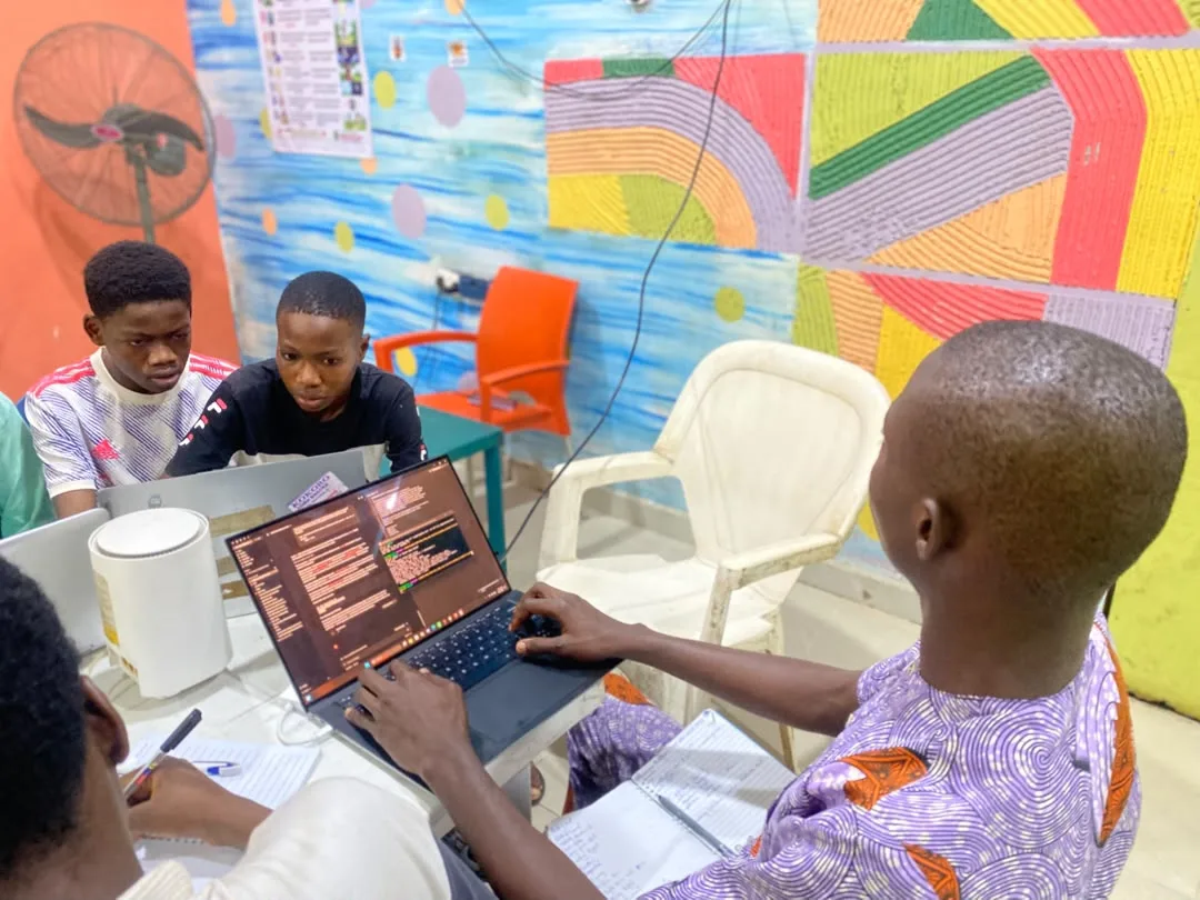 Students collaborating on a project at a laptop
